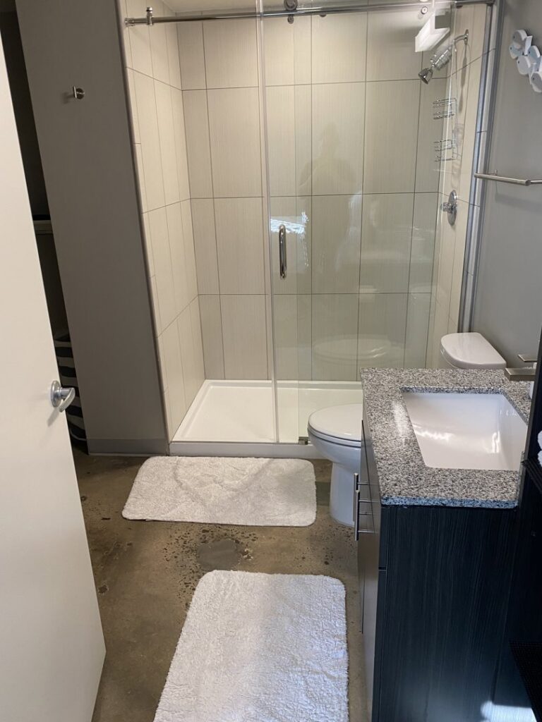 A sparkling clean bathroom featuring a modern shower and vanity, expertly cleaned by Inspire Clean OKC in Oklahoma City, OK.