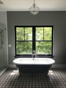 A sparkling clean bathroom featuring a freestanding tub and tiled floor, showcasing the quality of Bloom in Clean services in Bangor, ME.