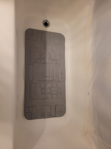 A sparkling clean bathtub with a bath mat, showcasing results from Ready.Set.Clean LLC in Morley, MI.