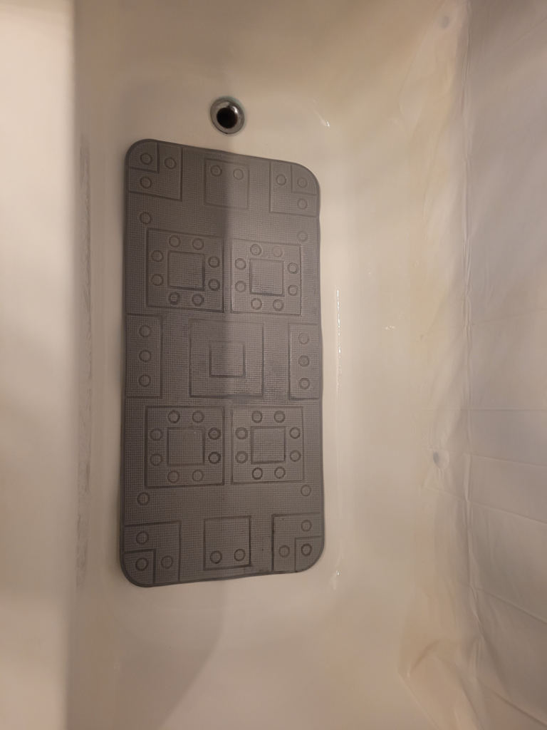 A sparkling clean bathtub with a bath mat, showcasing results from Ready.Set.Clean LLC in Morley, MI.