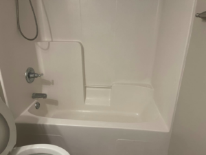 A sparkling clean white bathtub and shower area, showcasing the bathroom cleaning expertise of The Clean Solution in Eagle Lake, TX