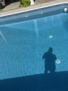 A sparkling clean, blue in-ground pool, showcasing the excellent results of Pips Pool Service in Enid, OK.