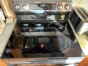 A sparkling clean electric stovetop, showcasing a professional cleaning result by The Scrub Club in Concord, NH.