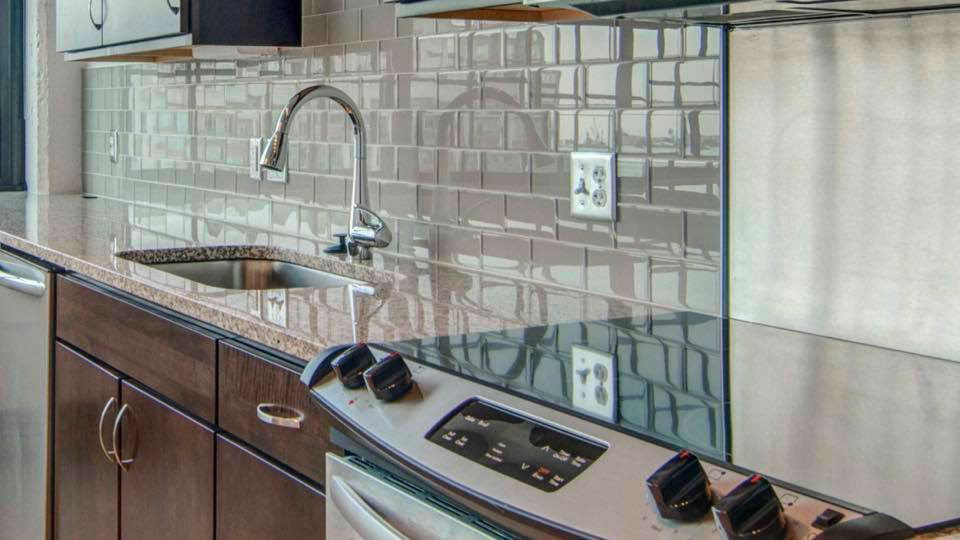 A sparkling clean kitchen counter, sink, and stove top, demonstrating house cleaning by A'La Carte Clean in Virginia Beach, VA.