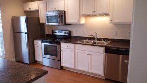 A sparkling clean kitchen with stainless steel appliances and white cabinets after professional cleaning by By Grace Cleaning Solutions, LLC in Cincinnati, OH.