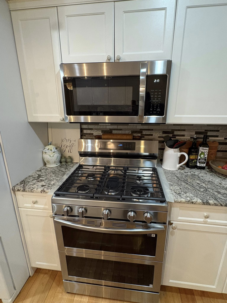 A sparkling clean kitchen with stainless steel appliances and granite countertops by HDew Cleaning Co. in Madison Heights, MI.