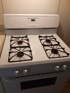 A sparkling clean white kitchen stove, demonstrating the thorough cleaning services by Active Cleaning in Virginia Beach, VA