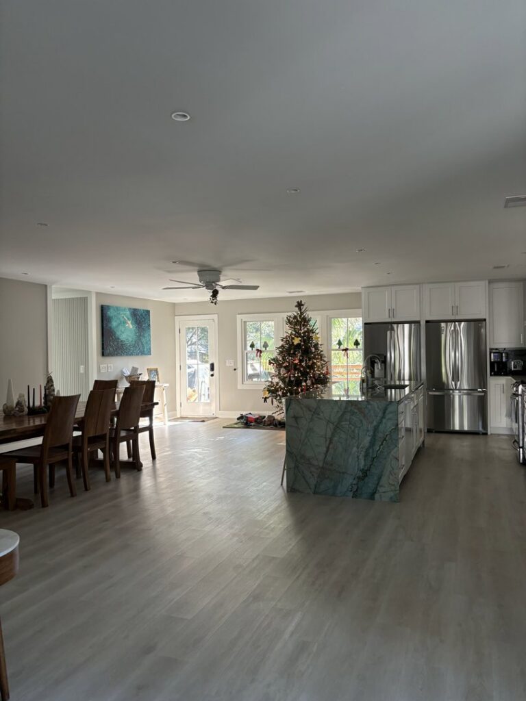 A sparkling clean and tidy open-plan living room and kitchen area, showcasing the results of Cleaning Sisters LLC's service in Richmond, VA.