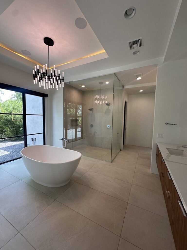 A sparkling clean modern bathroom with a freestanding tub and glass shower, cleaned by Cleaners of Arizona in Chandler, AZ.