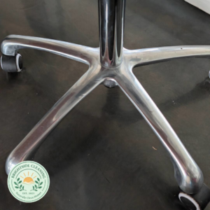 A sparkling clean, polished metal base of an office chair, showcasing the meticulous results of Maid by Lauren Cleaning Services in Fayetteville, AR.