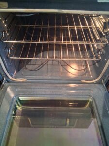 A sparkling clean oven interior with shiny racks, showcasing the results of professional oven cleaning by CleanSlate Cleaning Company in Lansing, MI.