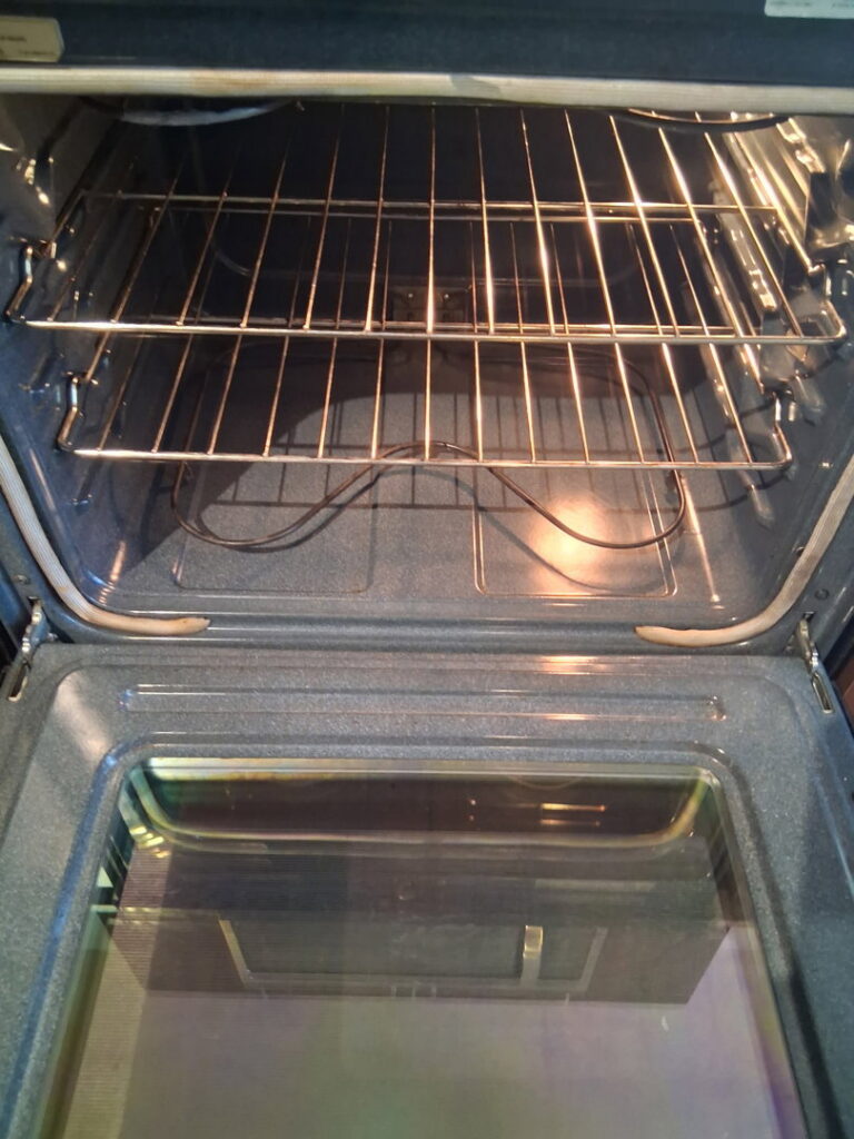 A sparkling clean oven interior with shiny racks, showcasing the results of professional oven cleaning by CleanSlate Cleaning Company in Lansing, MI.