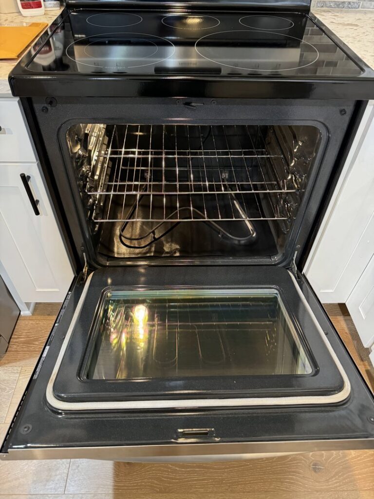 A sparkling clean oven interior with racks after professional deep cleaning by Nannie Needs LLC in Kent, WA.