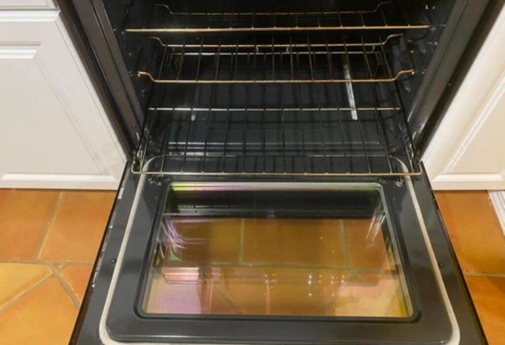 The sparkling clean interior of an oven with racks, demonstrating the detailed work of Best Bay Area Cleaners in Oakland, CA.