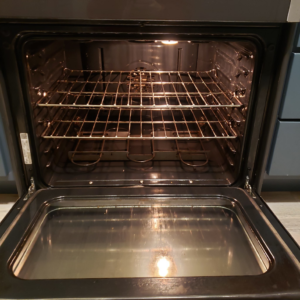 A sparkling clean oven interior with racks, demonstrating deep cleaning services by Quickcleanup full service cleaning in Juneau, AK.