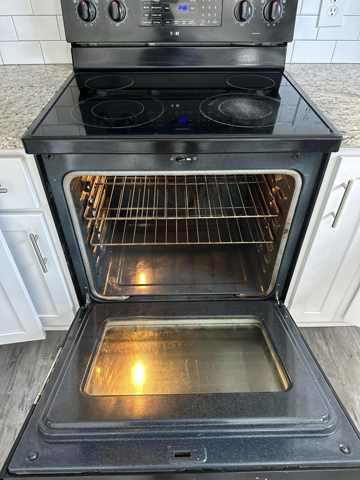 A sparkling clean oven with racks and a stovetop in a kitchen, demonstrating the deep cleaning by CLEAN That SHEET LLC in Jacksonville, FL.