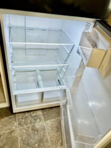 The sparkling clean interior of an empty refrigerator, showcasing professional cleaning by Elite A&C Cleaning, LLC in Casper, WY.