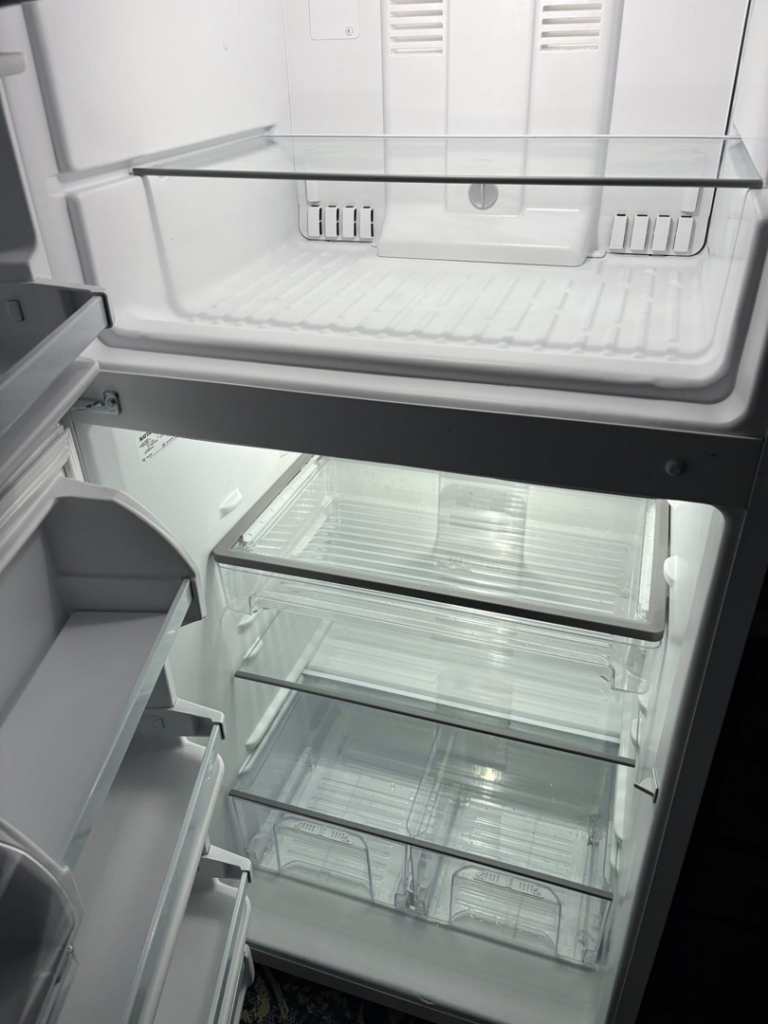 A sparkling clean refrigerator interior with spotless shelves and drawers, cleaned by Sprinkled Clean in Bangor, ME.