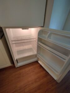 A sparkling clean and empty refrigerator interior, showcasing deep cleaning services by Tessa's Cleaning Service in Chesapeake, VA.