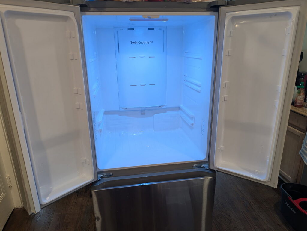 A sparkling clean and empty refrigerator interior, showcasing professional appliance cleaning by Wilkie Wonders Cleaning in Akron, OH.