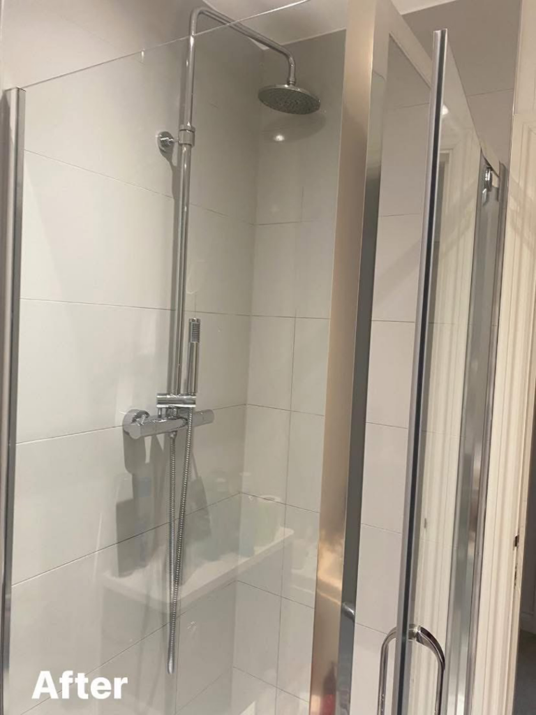 A sparkling clean shower with white tiles and shiny fixtures after service by Nicy Cleaning Service in Danbury, CT.