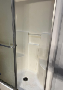 A sparkling clean shower stall after professional cleaning by Crystal's Small Town Cleaning Company, LLC in Oelwein, IA.