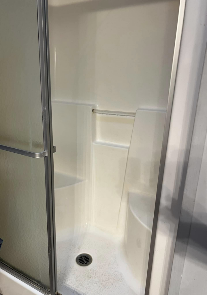 A sparkling clean shower stall after professional cleaning by Crystal's Small Town Cleaning Company, LLC in Oelwein, IA.
