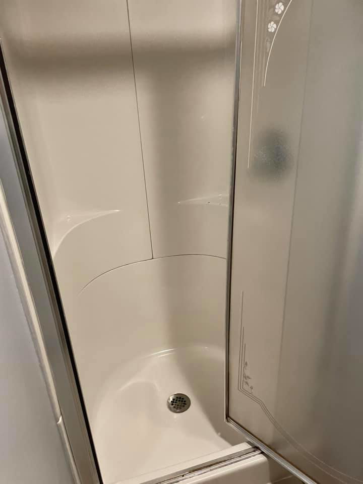 A sparkling clean shower stall with clear glass doors, showcasing the quality work of Every Time Cleaning in Cedar Rapids, IA.
