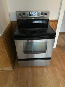 A sparkling clean stainless steel oven and stovetop, meticulously cleaned by Kings and Queens of the Most High Cleaning Services in Akron, OH.