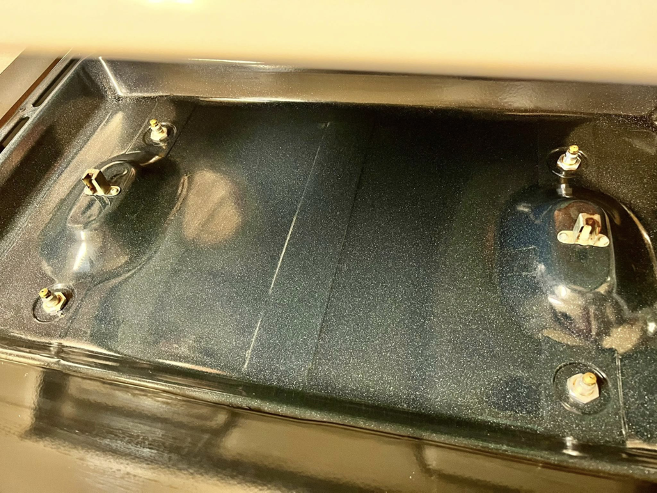 A sparkling clean stove oven interior, showcasing the results of professional house cleaning by Masters Touch Cleaning Solutions LLC.