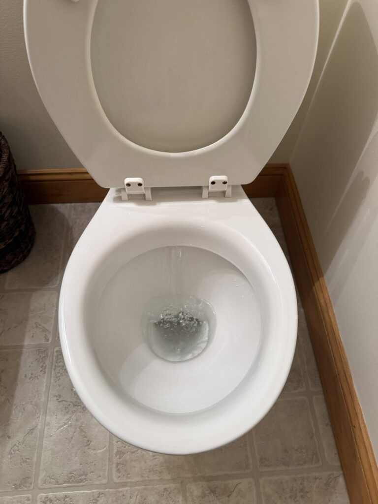 A sparkling clean toilet after a professional house cleaning service by KDG Decluttering in Manchester, NH.