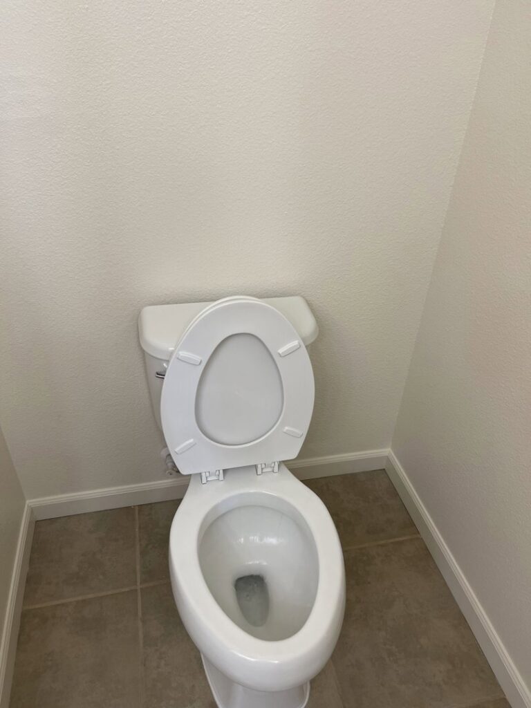 A sparkling clean toilet in a well-maintained bathroom, demonstrating the meticulous cleaning standards of 307 Maid in Cheyenne, WY.