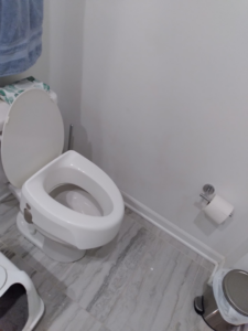 A sparkling clean toilet and tiled bathroom floor, professionally cleaned by Squeaky Clean By: Nikki in Chicago, IL.