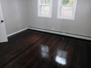 A sparkling dark hardwood floor in a freshly cleaned room by Sanchez Cleaning Service, LLC in San Antonio, TX.