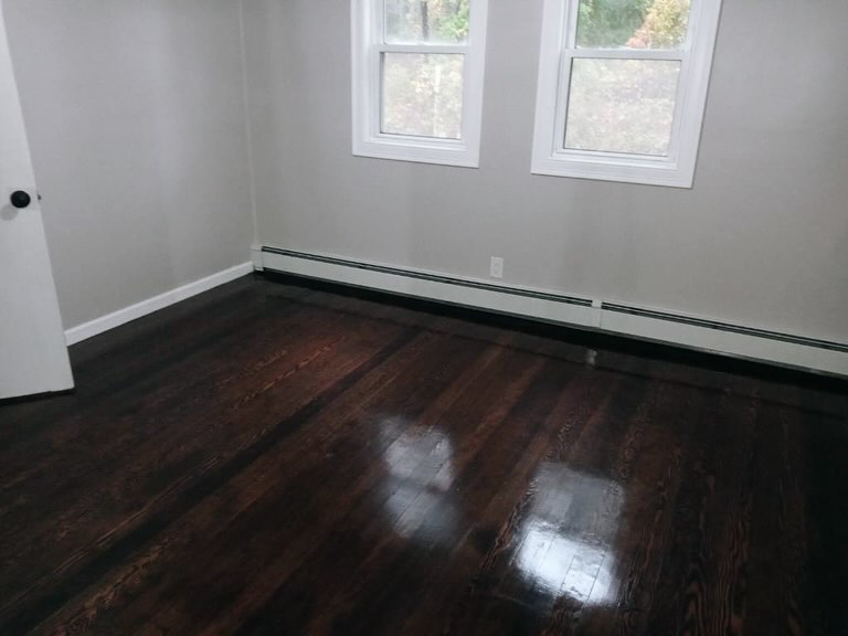A sparkling dark hardwood floor in a freshly cleaned room by Sanchez Cleaning Service, LLC in San Antonio, TX.