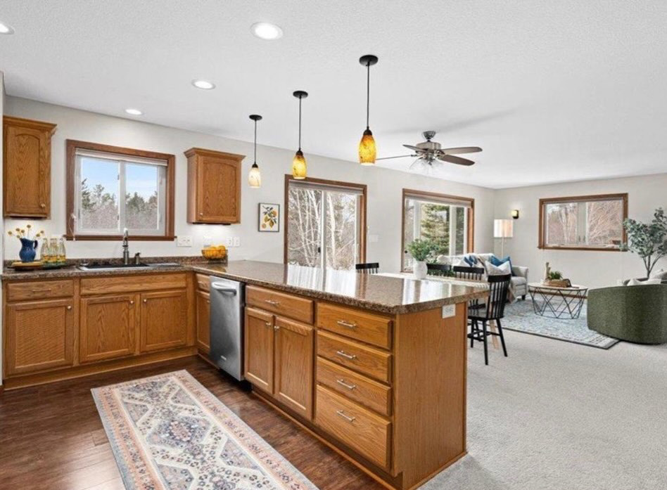 A sparkling clean kitchen featuring a large island and polished countertops, a result of Tidy Details house cleaning in Duluth, MN.