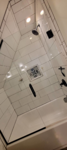 A sparkling clean tiled shower and bathtub, demonstrating professional house cleaning by Rachel Blume Residential Cleaning Specialist in Sheridan, WY.