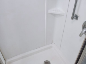 A sparkling white shower stall, meticulously cleaned by Sanchez Cleaning Service, LLC in San Antonio, TX.