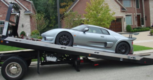 A silver sports car being loaded onto a flatbed tow truck by Roseville Tow Truck Company in Roseville, CA