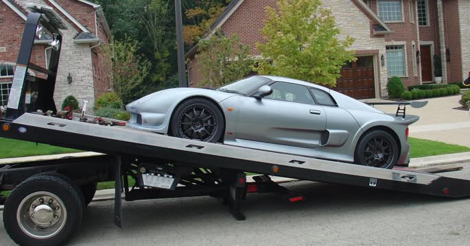 A silver sports car being loaded onto a flatbed tow truck by Roseville Tow Truck Company in Roseville, CA