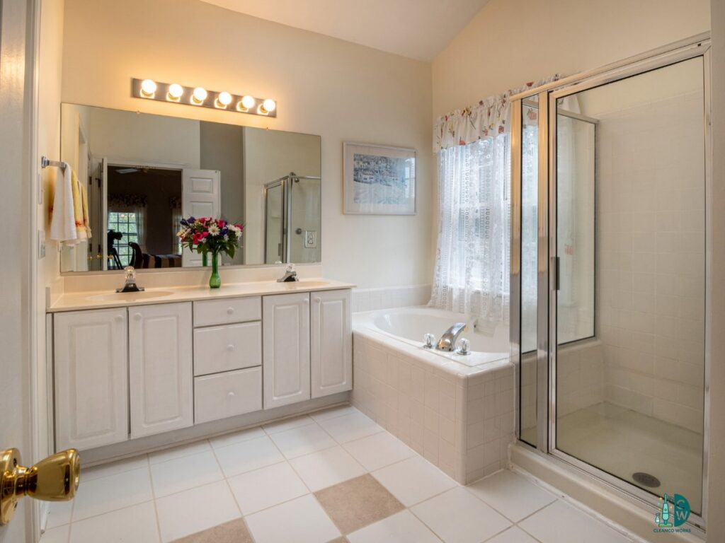 A spotless and well-maintained bathroom with a double vanity, bathtub, and shower, reflecting the high standards of CleanCo Works in Scottsdale, AZ.