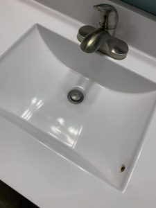 A spotless white bathroom sink and shiny faucet, demonstrating the quality cleaning by Remy the Cleaner in Indianapolis, IN.