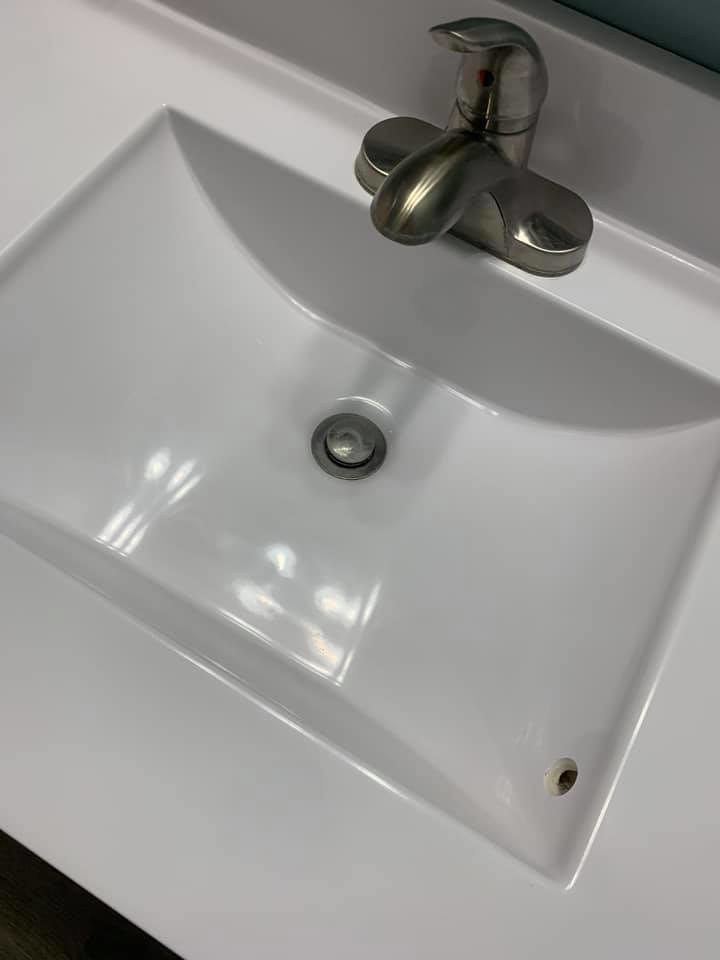 A spotless white bathroom sink and shiny faucet, demonstrating the quality cleaning by Remy the Cleaner in Indianapolis, IN.