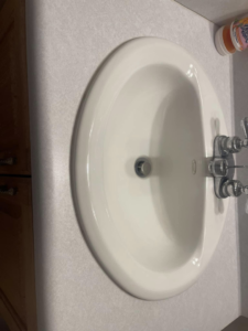 A spotless white bathroom sink and countertop, demonstrating the meticulous cleaning by The Clean Solution in Eagle Lake, TX