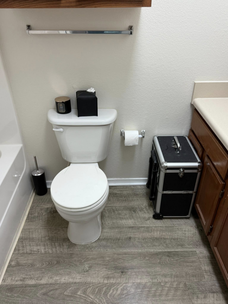 A spotless bathroom with a clean toilet and vanity, showing the quality cleaning by WWJM Cleaning Service in Oklahoma City, OK.