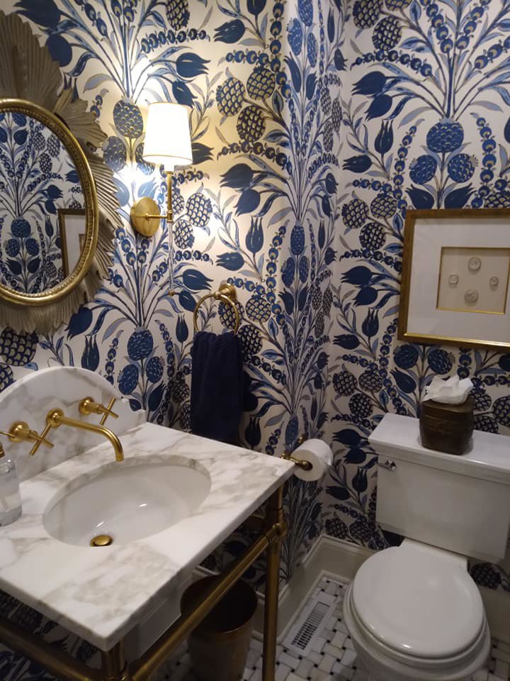A spotless bathroom with elegant patterned wallpaper, cleaned to perfection by Jessie Clean in Indianapolis, IN.
