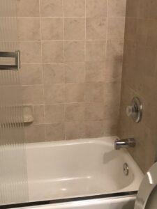 A spotless bathtub and tiled shower wall, reflecting the thorough house cleaning provided by A Clean Xscape LLC in Chandler, AZ.