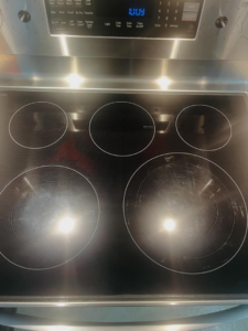 A perfectly clean and shiny electric stovetop after professional cleaning by BLACK PEARL Cleaning CO. in Greenwood, MO.