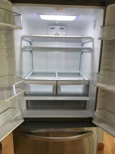 A spotless and empty refrigerator interior, demonstrating the deep cleaning services offered by Bloom in Clean in Bangor, ME.