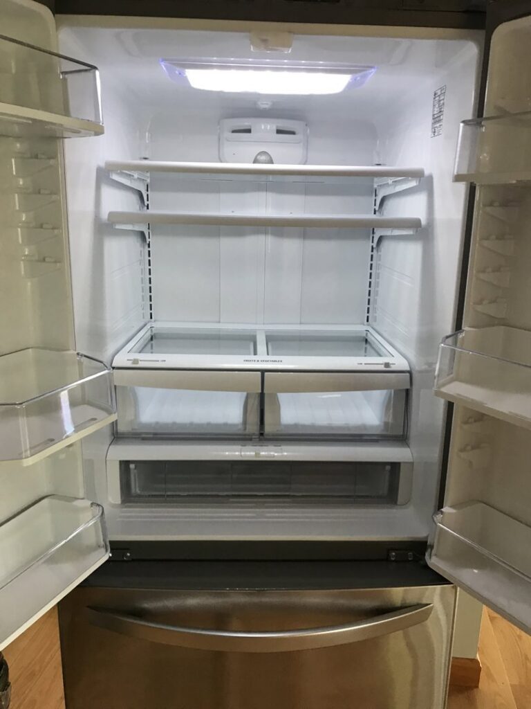 A spotless and empty refrigerator interior, demonstrating the deep cleaning services offered by Bloom in Clean in Bangor, ME.